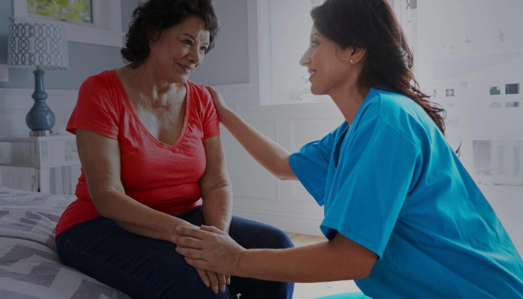 Nurse speaking with a patient in an exam room