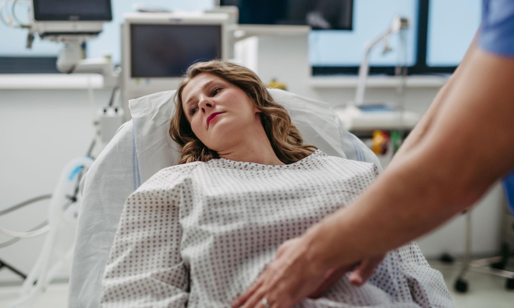 Healthcare provider explaining when stomach pain requires a walk-in clinic versus emergency room visit in Longview TX