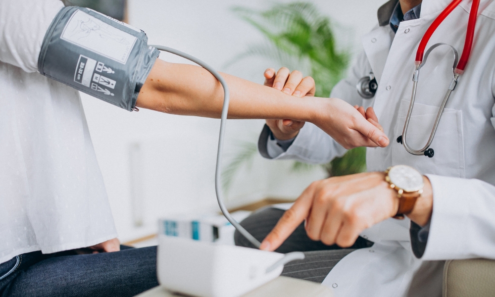 Primary care provider checking a patient's blood pressure in Longview TX