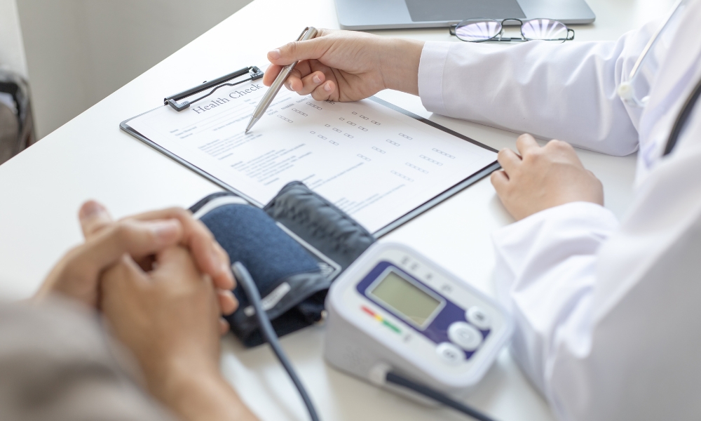 Doctor discussing hypertension treatment and healthy lifestyle changes with patient in Longview TX
