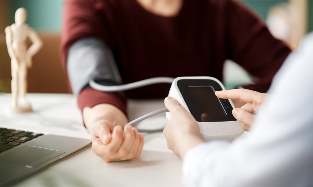 Healthcare provider checking a patient's blood pressure during a primary care visit in Longview TX